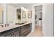 Elegant bathroom with double vanity and walk-in closet access at 8020 Moonbeam Ave, Sarasota, FL 34241