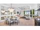 Bright dining room features a large chandelier and seating for six at 8020 Moonbeam Ave, Sarasota, FL 34241