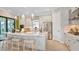 Modern kitchen featuring white shaker cabinets, stainless steel appliances, and a center island at 8020 Moonbeam Ave, Sarasota, FL 34241
