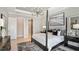 Luxurious main bedroom with a large bed and a chandelier at 8020 Moonbeam Ave, Sarasota, FL 34241