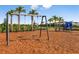 Community playground with swings and play structure at 8020 Moonbeam Ave, Sarasota, FL 34241