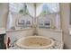 Spa-like bathroom with corner soaking tub, double vanity, and decorative accents at 8334 Sailing Loop, Lakewood Ranch, FL 34202