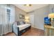 Bedroom with a daybed, TV, and access to pool at 8334 Sailing Loop, Lakewood Ranch, FL 34202