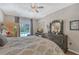 Spacious bedroom with king bed, dark wood furniture, and sliding door to patio at 8334 Sailing Loop, Lakewood Ranch, FL 34202