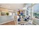 Charming dining room with an oval table and white chairs, and large windows at 8334 Sailing Loop, Lakewood Ranch, FL 34202