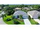 Single-story home with gray tile roof and lush landscaping at 8334 Sailing Loop, Lakewood Ranch, FL 34202