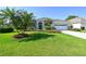 One-story home with gray tile roof, white walls, and palm trees at 8334 Sailing Loop, Lakewood Ranch, FL 34202