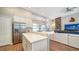 Spacious kitchen with island, stainless steel appliances, and white cabinetry at 8334 Sailing Loop, Lakewood Ranch, FL 34202
