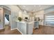Bright kitchen boasts white cabinets, stainless steel appliances, and hardwood floors at 8334 Sailing Loop, Lakewood Ranch, FL 34202