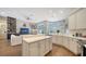 Open kitchen features white cabinets, upgraded countertops, and breakfast bar at 8334 Sailing Loop, Lakewood Ranch, FL 34202