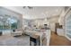 Open concept living room with kitchen views and access to pool area at 8334 Sailing Loop, Lakewood Ranch, FL 34202