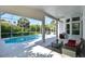 Screened pool area with patio furniture and lush landscaping at 8334 Sailing Loop, Lakewood Ranch, FL 34202