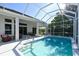 Inviting pool area with screened enclosure and patio furniture at 8334 Sailing Loop, Lakewood Ranch, FL 34202