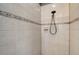 A tiled shower stall with a modern shower head at 8334 Sailing Loop, Lakewood Ranch, FL 34202