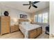 Bright bedroom with a queen-size bed, wood floors, and ceiling fan at 8544 54Th Avenue E Cir, Bradenton, FL 34211