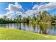 Serene lakefront view with lush greenery and a bright sky at 8544 54Th Avenue E Cir, Bradenton, FL 34211