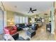 Relaxing living room with comfortable leather furniture and a ceiling fan at 8544 54Th Avenue E Cir, Bradenton, FL 34211