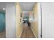 Hallway with wood-look flooring and soft yellow walls at 1201 56Th W St, Bradenton, FL 34209