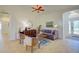 Living room with tiled flooring, a gray sofa, two armchairs, and decorative accents at 12086 Granite Woods Loop, Venice, FL 34292