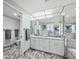 Bathroom with double vanity, marble floors, and mirrored walls at 1211 Gulf Of Mexico Dr # 105, Longboat Key, FL 34228