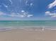 Tranquil beach with gentle waves and vast blue sky at 12583 Sagewood Dr, Venice, FL 34293