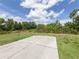 Large grassy backyard with a concrete pad, perfect for outdoor activities at 1296 Skagway Ter, North Port, FL 34291