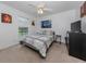 Spacious bedroom with a queen-size bed and large window at 1296 Skagway Ter, North Port, FL 34291