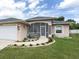 House exterior featuring a screened porch and well-maintained landscaping at 1296 Skagway Ter, North Port, FL 34291