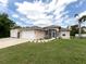 Single-story home with attached garage and landscaped front yard at 1296 Skagway Ter, North Port, FL 34291