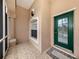 Screened-in front porch with tiled flooring and a green door at 1296 Skagway Ter, North Port, FL 34291