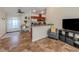 Open kitchen features stainless steel appliances and breakfast bar at 1296 Skagway Ter, North Port, FL 34291