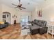 Living room features high ceilings, gray sectional, and sliding doors at 1296 Skagway Ter, North Port, FL 34291