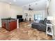 Spacious living room with gray sectional sofa and tile floors at 1296 Skagway Ter, North Port, FL 34291