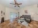 Living room features high ceilings, gray sectional, and sliding doors at 1296 Skagway Ter, North Port, FL 34291