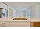 Close-up view of a kitchen island with a stainless steel sink and quartz countertop at 14010 Ginnie Springs Way, Parrish, FL 34219