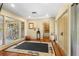 Bright foyer with wood floors, a unique rug, and natural light from large windows at 1501 Peregrine Point Dr, Sarasota, FL 34231