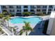 Aerial view of the pool, hot tub, and surrounding lounge area at 1709 N Tamiami Trl # 214, Sarasota, FL 34234