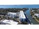 Stunning aerial view of waterfront condos nestled alongside a marina with boats and ocean views at 1709 N Tamiami Trl # 214, Sarasota, FL 34234