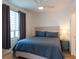 Comfortable bedroom with a king-size bed, blue bedding, and modern decor at 1709 N Tamiami Trl # 214, Sarasota, FL 34234
