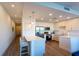 Open-concept kitchen with stainless steel appliances, white countertops, and a breakfast bar at 1709 N Tamiami Trl # 214, Sarasota, FL 34234