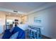 Coastal living room with blue sofa, unique surfboard table, and open kitchen at 1709 N Tamiami Trl # 214, Sarasota, FL 34234