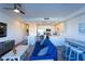 Inviting living area with blue sofa, surfboard-style bar table, and open kitchen at 1709 N Tamiami Trl # 214, Sarasota, FL 34234