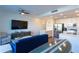 Open-concept living area with modern kitchen, stainless steel appliances, and a unique surfboard dining table at 1709 N Tamiami Trl # 214, Sarasota, FL 34234