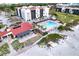 Aerial view showing pool, building, and beach access at 1935 Gulf Of Mexico Dr # G7-302, Longboat Key, FL 34228