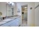 Modern bathroom featuring white vanity, granite countertop, and ample storage at 1935 Gulf Of Mexico Dr # G7-302, Longboat Key, FL 34228