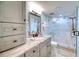 Updated bathroom with stone countertop, ample storage, and tiled glass walk-in shower at 1935 Gulf Of Mexico Dr # G7-302, Longboat Key, FL 34228