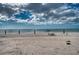 Peaceful beach view with calm ocean and cloudy sky at 1935 Gulf Of Mexico Dr # G7-302, Longboat Key, FL 34228