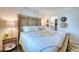 Relaxing bedroom with comfortable bed, closet access, and charming decorations at 1935 Gulf Of Mexico Dr # G7-302, Longboat Key, FL 34228