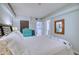 Bright bedroom with teal dresser and comfortable bed at 1935 Gulf Of Mexico Dr # G7-302, Longboat Key, FL 34228