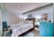 Cozy bedroom with wooden bed, blue dresser, and coastal-themed decor at 1935 Gulf Of Mexico Dr # G7-302, Longboat Key, FL 34228